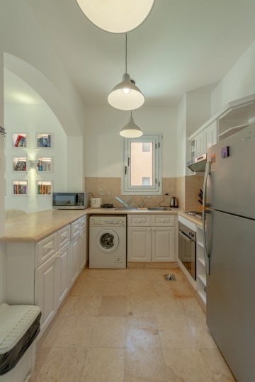 Fully equipped kitchen with washing machine, microwave, toaster, oven and kettle