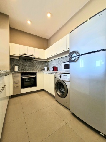 Large, fully equipped, and spacious kitchen for cooking, complete with a washing machine and dishwasher