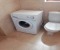 Bathroom with shower and washing machine