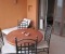 Spacious balcony with table and sun bed