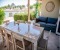 Large dining table on the outside terrace with sofa 