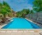 Shared pool with sun loungers and parasol