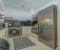 Fully equipped kitchen with washing machine, kettle, microwave, and coffee machine