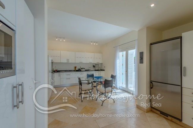 Back part of the kitchen with a large fridge