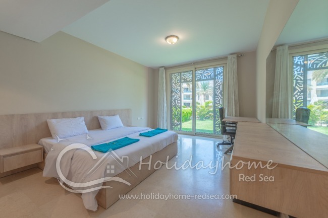 Bedroom with double bed and pool view