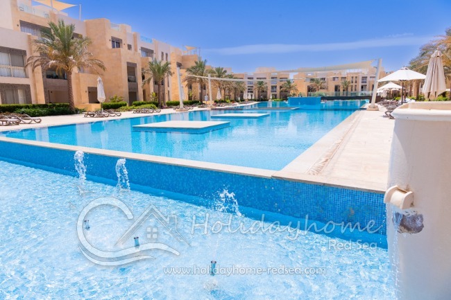 Shared pool with sunbeds