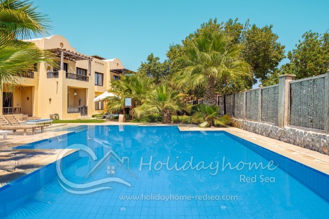 Large shared pool with garden.