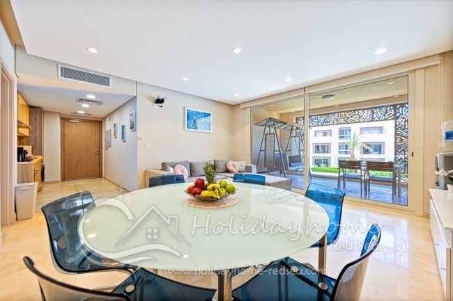 Open kitchen, modern living room and large dining table.