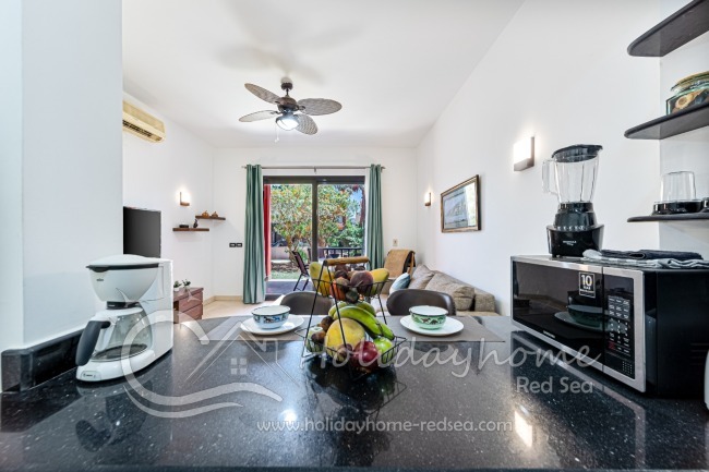 Fully equipped kitchen with washing machine, kettle, microwave, and coffee machine