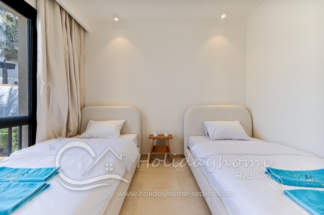 Two large single beds in the second bedroom