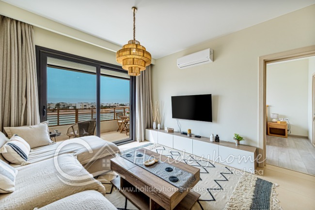 Living room with smart TV and balcony