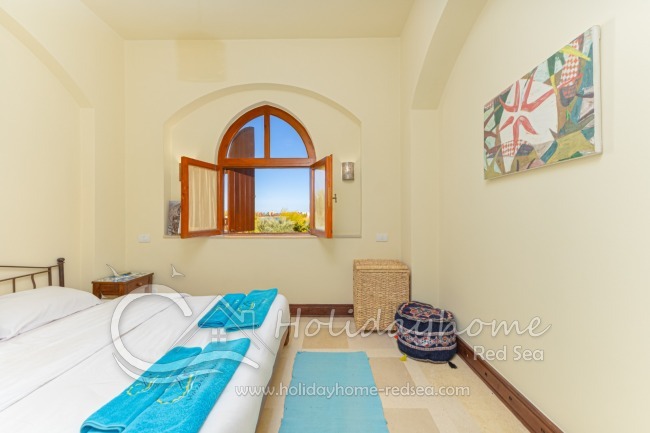 Bedroom with double bed and lagoon view