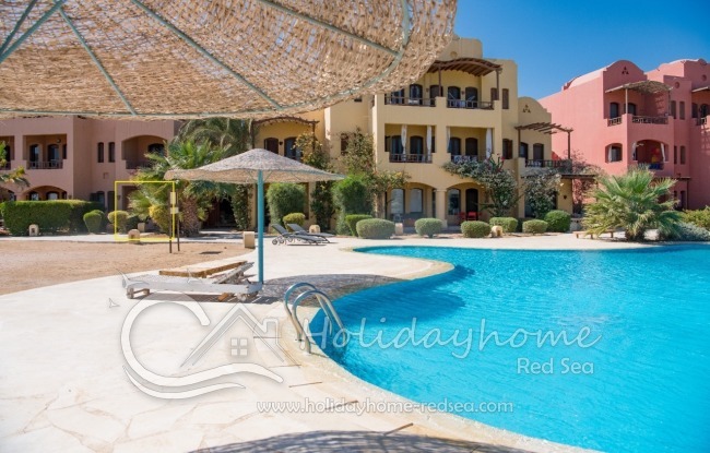 Shared pool with sunbeds