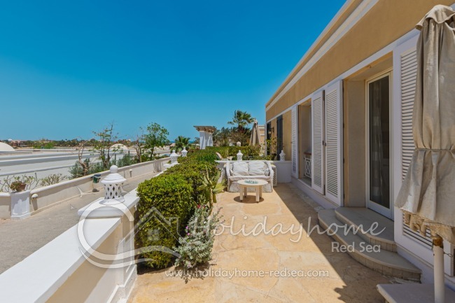 Terrace on the side of the house, with cozy sitting corner and access from the living room 